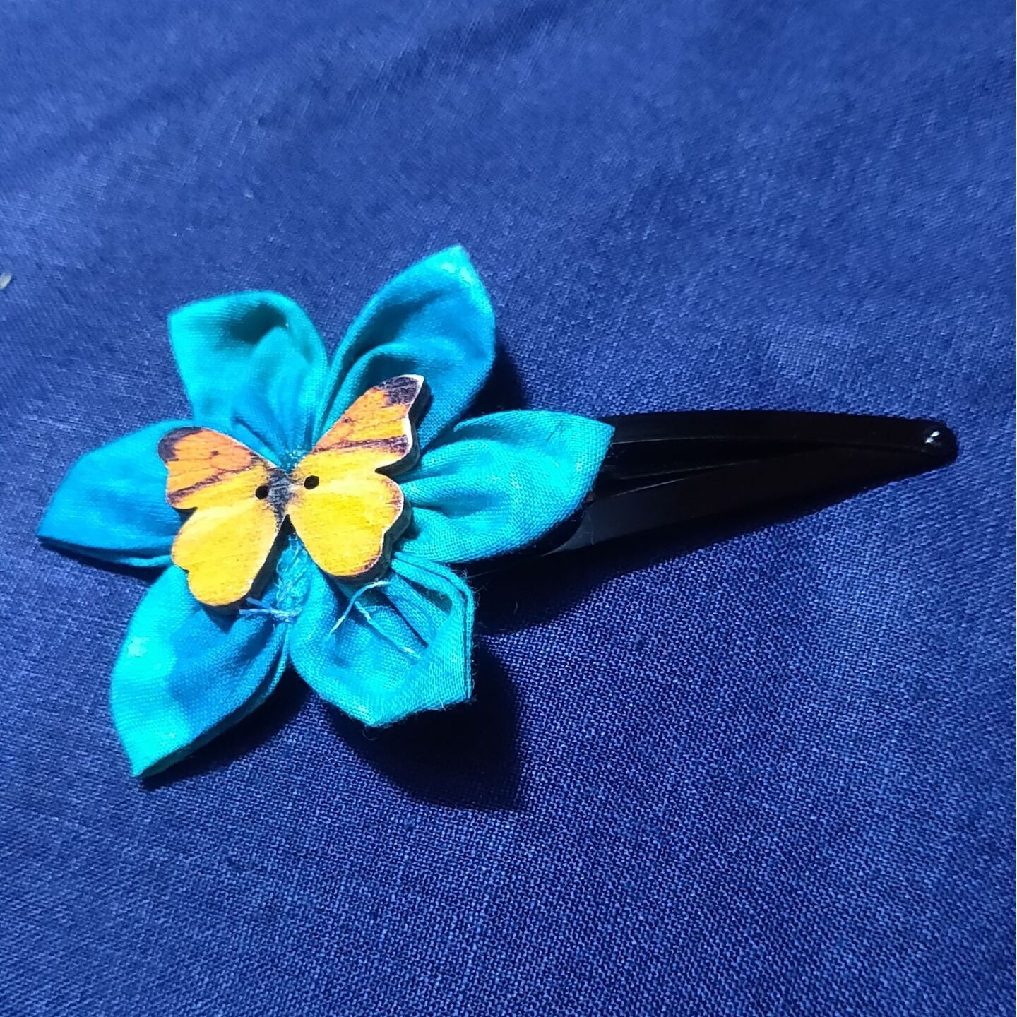 Tic tac clip with fabric flower with butterfly button