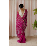 Handloom handembroidered organza resham silk saree enhanced with zari thread scallops.