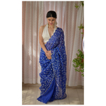 Handloom handembroidered organza resham silk saree enhanced with zari thread scallops.