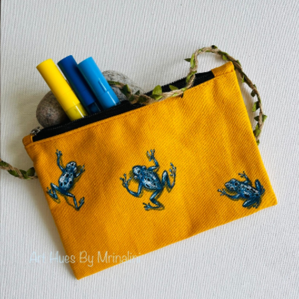 Blue Poison dart frog hand painted on a fabric pouch to store make up