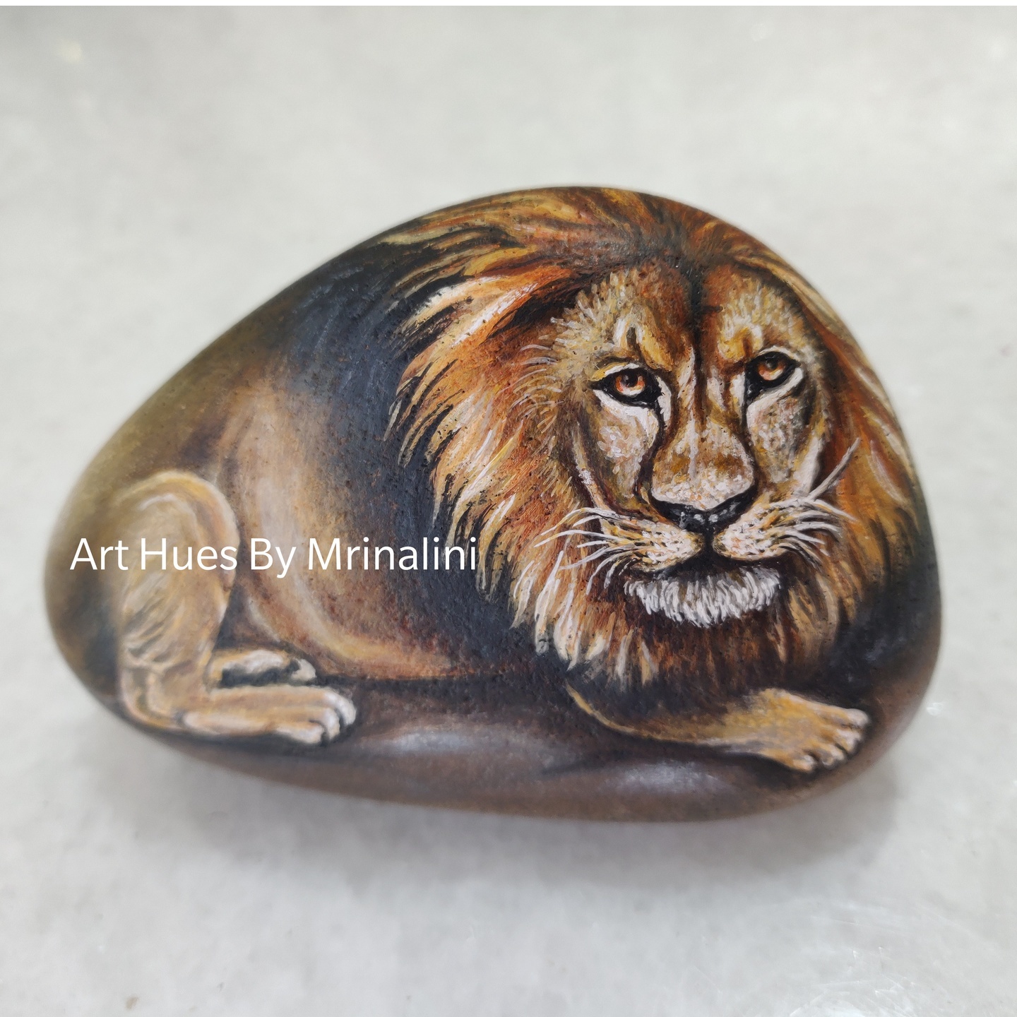 Lion sitting on a pride rock hand painted rock for wildlife enthusiast