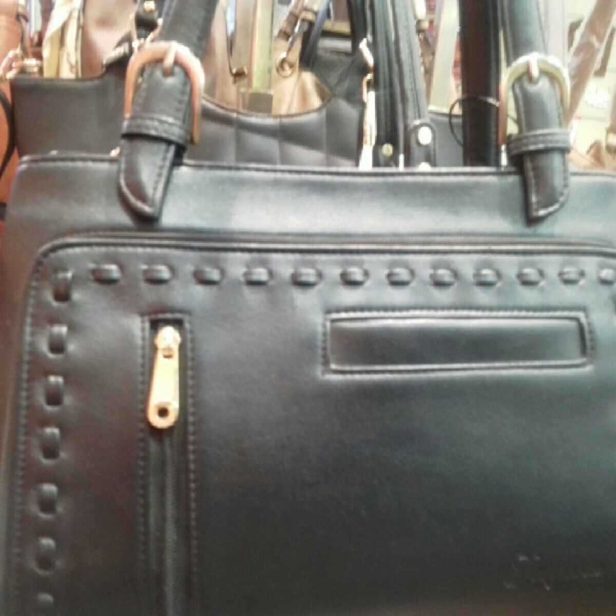 Black colour handbag Taneja brand for women.