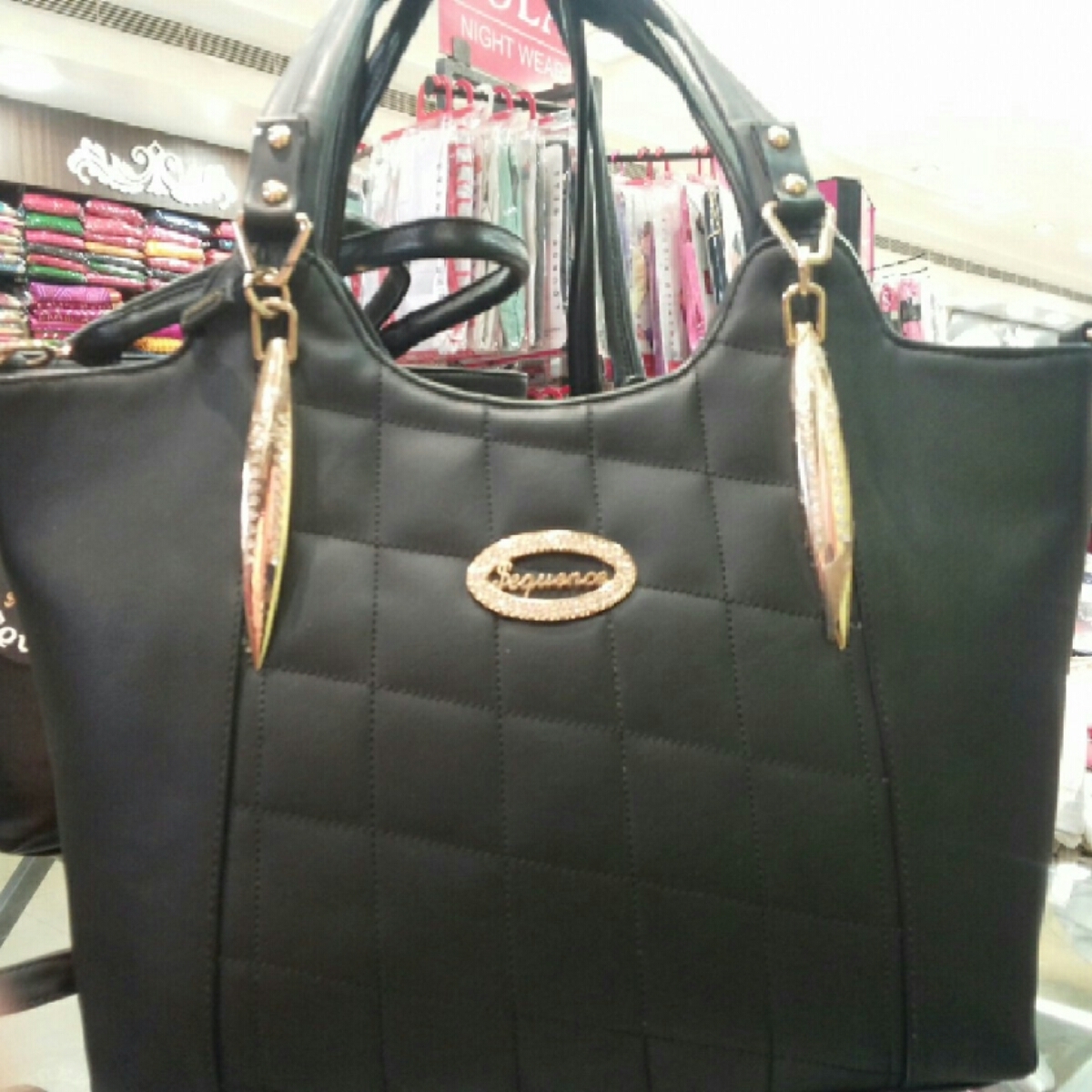 Black colour handbag Taneja brand for women.