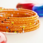Orange  beaded African coil bracelets