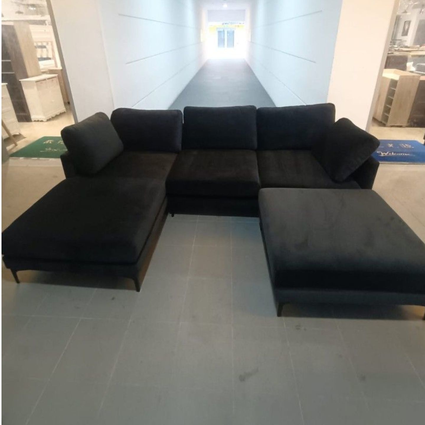 LAMBERT L-Shaped Sectional Sofa in PITCH BLACK VELVET with Ottoman fitted with Black Powder Coated Legs (right when seated)