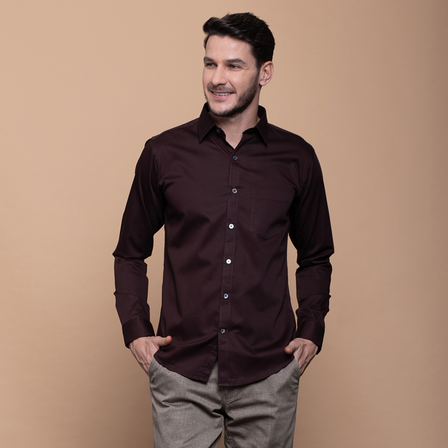 A man is wearing a spread collar shirt in brown colour