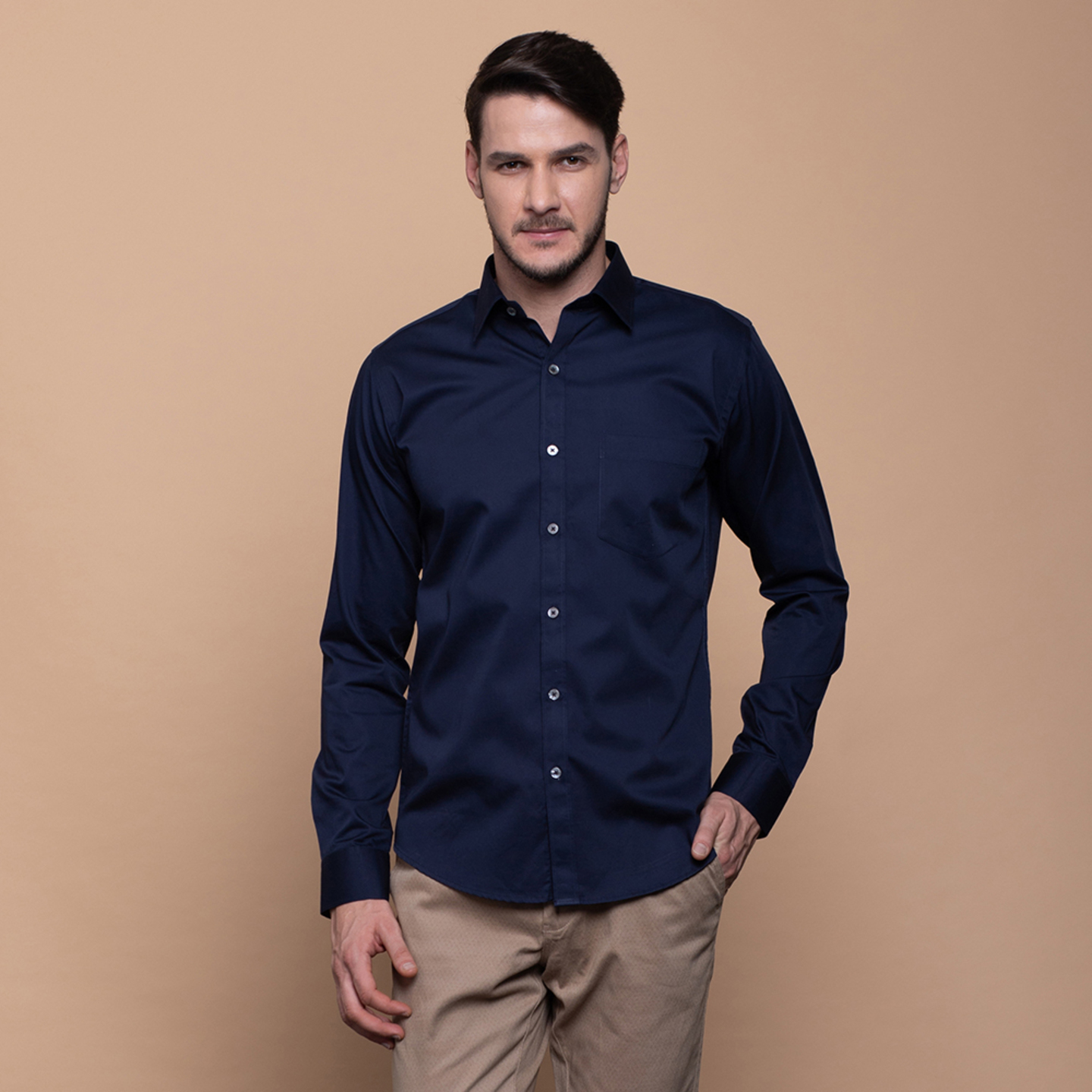 A man is wearing a spread collar shirt in navy blue colour
