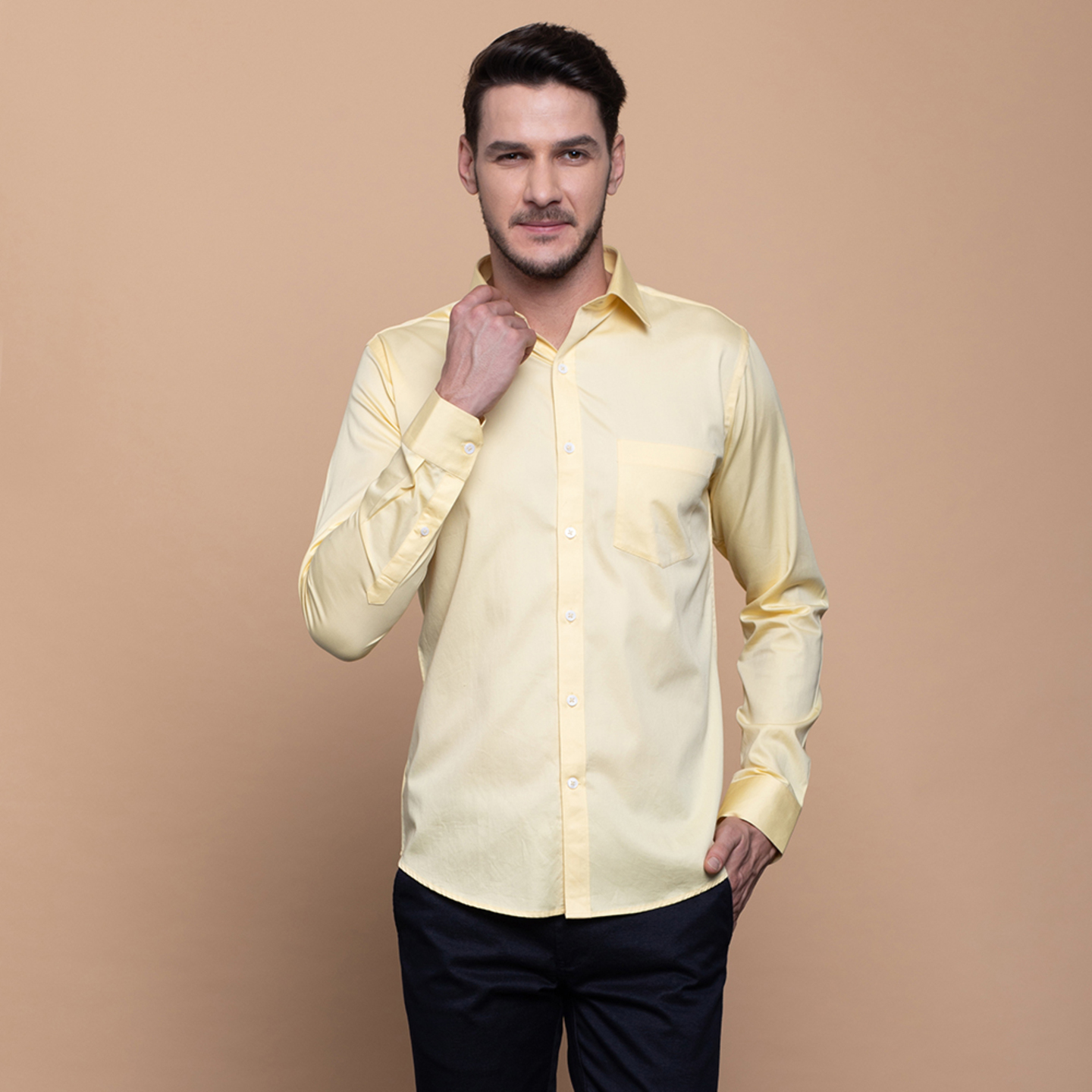 A man is wearing a spread collar shirt in yellow colour