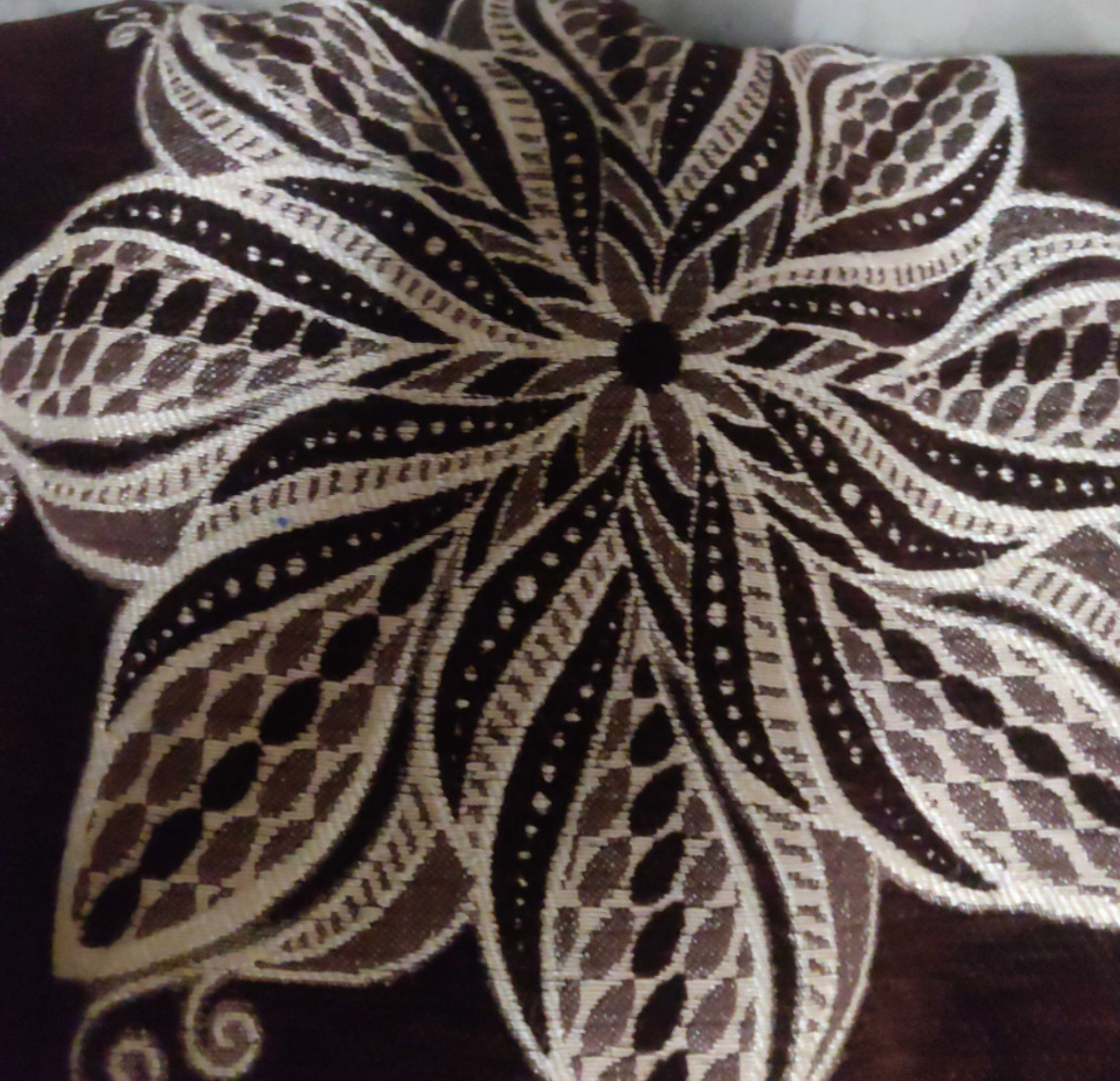 Beautifully stiched flower on brown cotton material