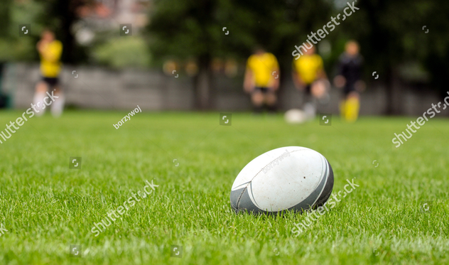 stock-photo-rugby-ball-at-green-grass-photo-taken-at-rugby-training-124748542.jpg