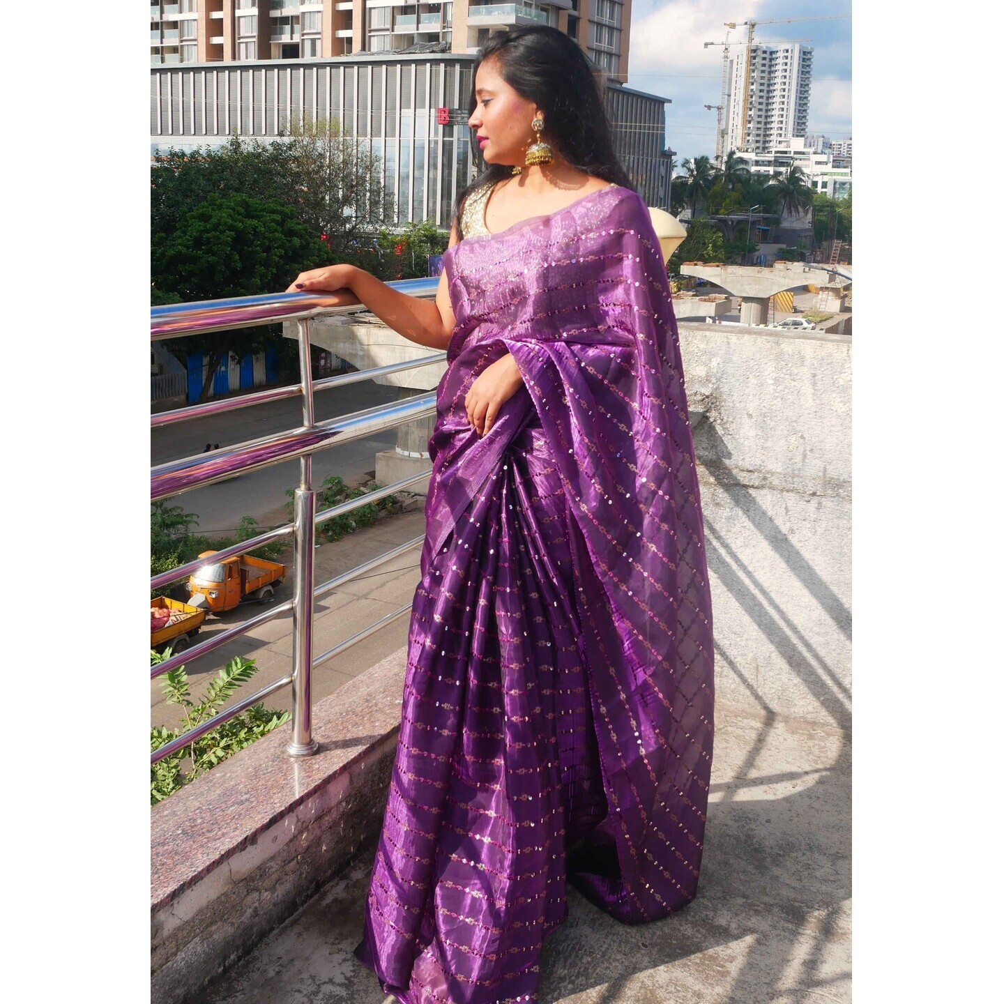 Exquisite purple saree with sparkling work.