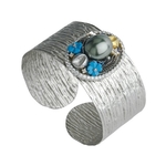 White and yellow gold cuffs, embellished with precious elements, using the art of embroidery.