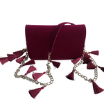 Front view of TASSIE ruby velvet crossbody bag with tassels