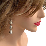 Model wearing RAJNI silver tone tier-drop earrings