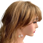 Model wearing BOBBIE large bauble ear hoops