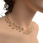 Model wearing VINI modular pearl vine necklace around the neck