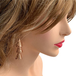 Model wearing RAJNI rose gold tone tier-drop earrings