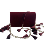 Front view of TASSIE burgundy velvet crossbody bag with tassels