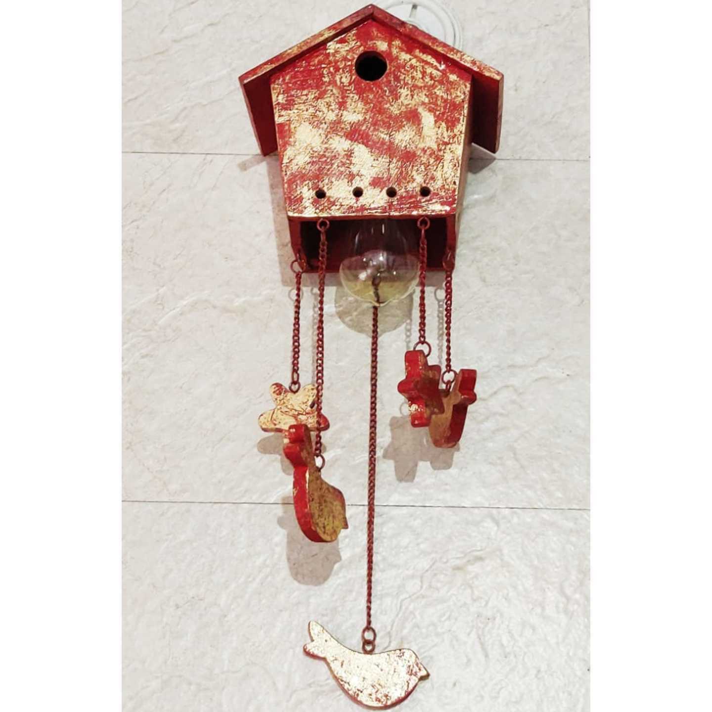 Antique Wooden Hut Wall Lamp With Ornaments Hanging From it   