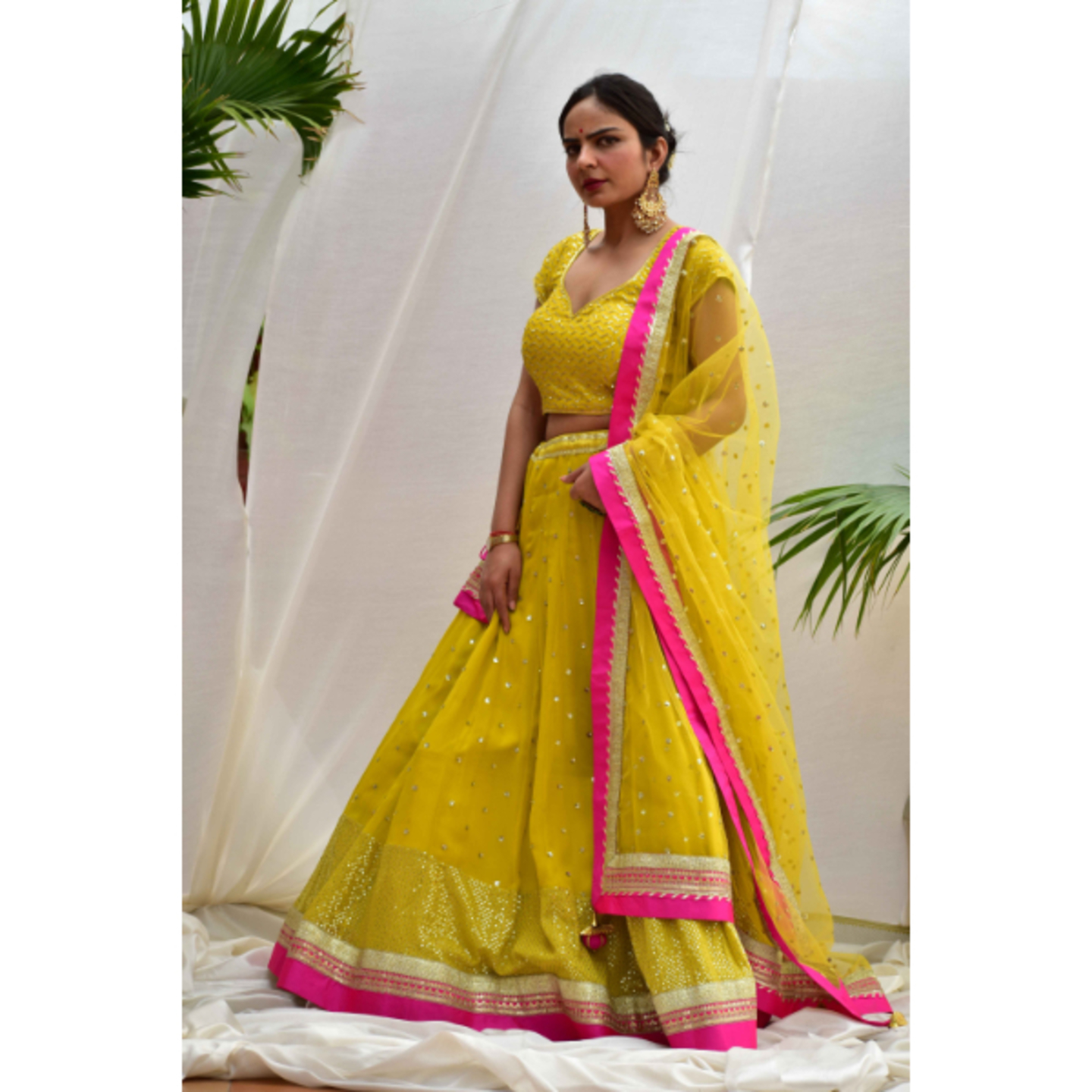 NOOR Canary-yellow Lehenga set in sequins embroidery with magenta detailing.