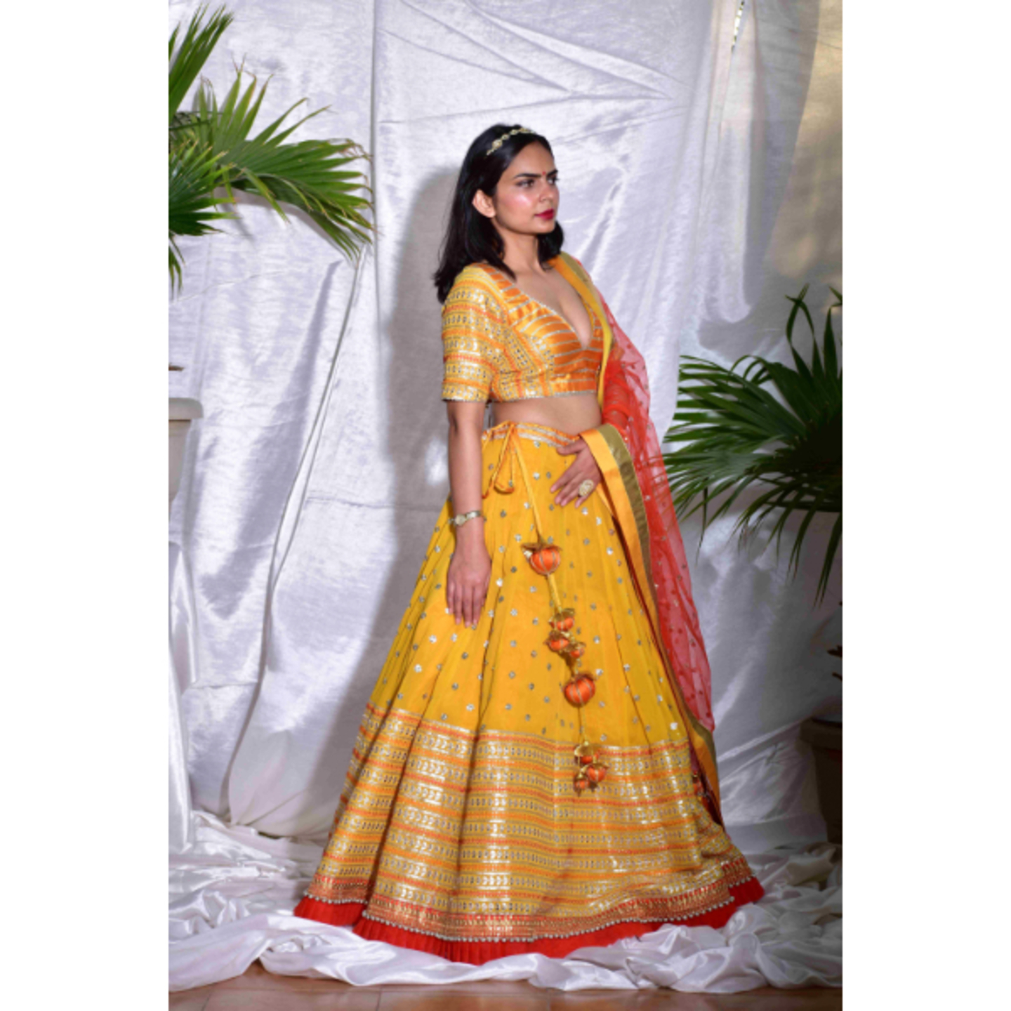 AMJI Canary Yellow, Rust and Gold Lehenga set in cheerful gota embroidery.