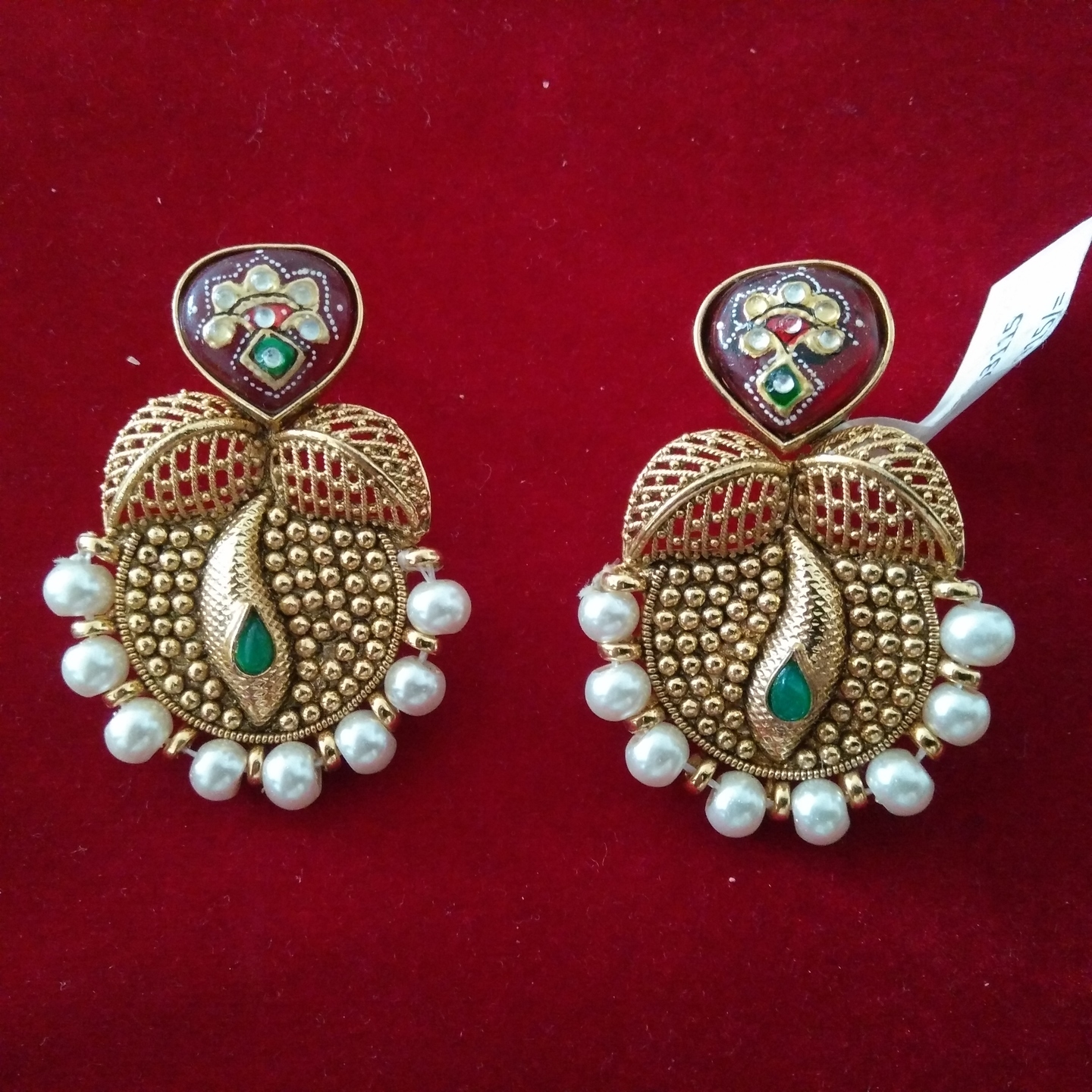 Golden earrings with green red enamel work and white stones